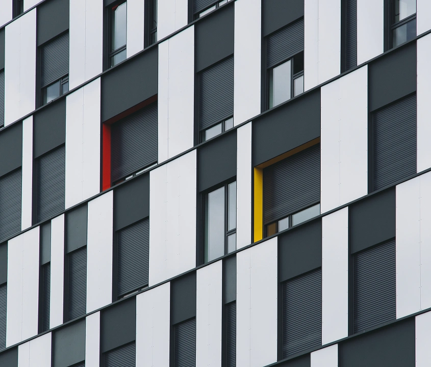 Black and white modern building facade with window accents by General Contractor Covington WA.