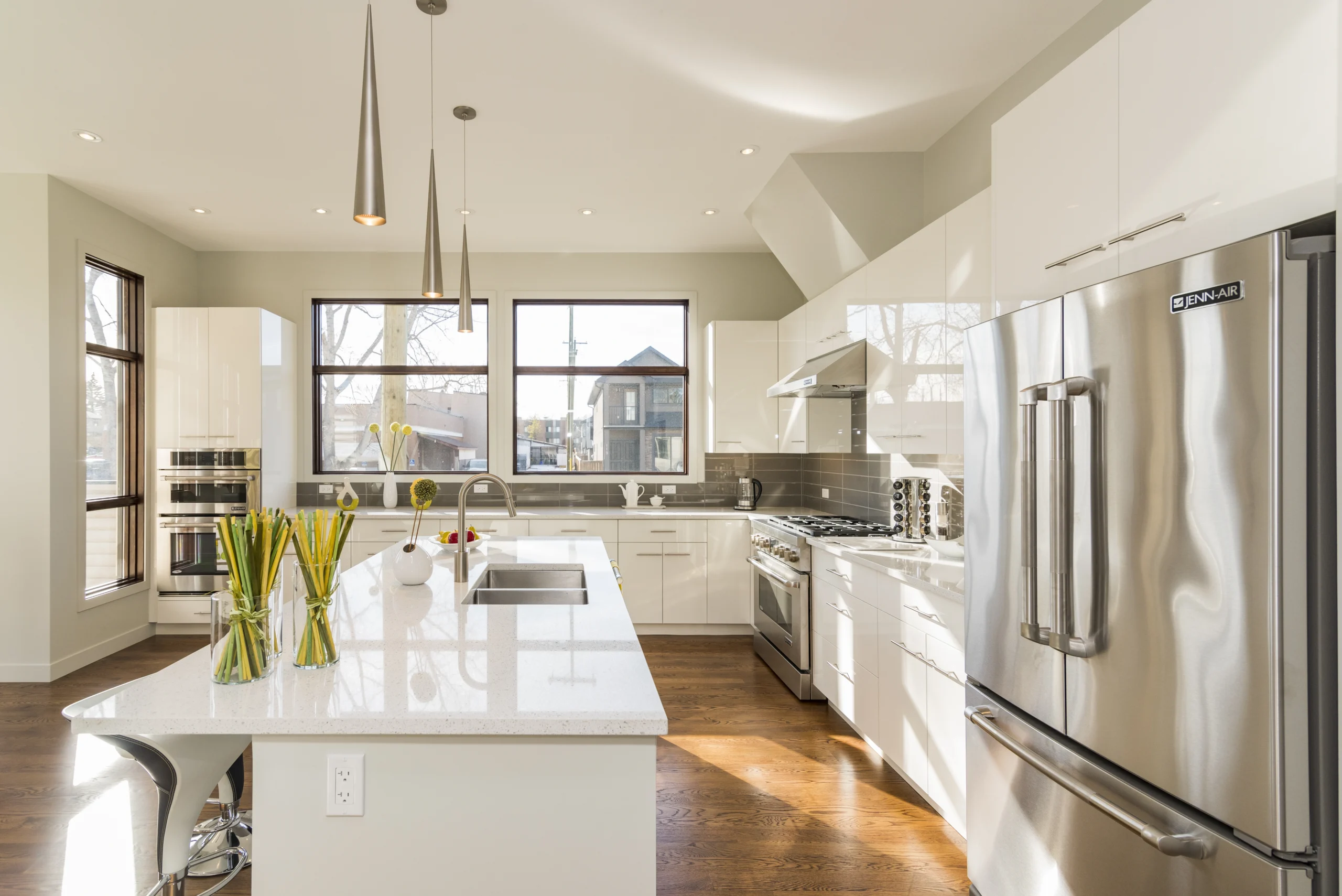 White quartz island and stainless steel appliances in a stunning Kitchen Remodel Covington WA.