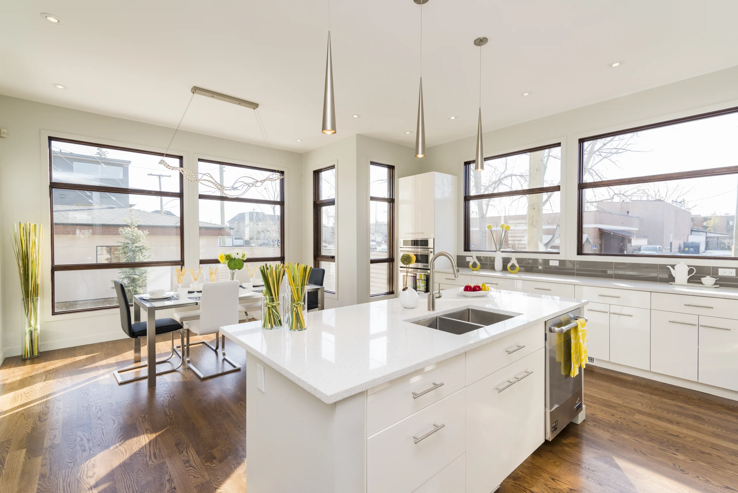 Large windows fill a beautiful Kitchen Remodel Covington WA with natural light illuminating the island.
