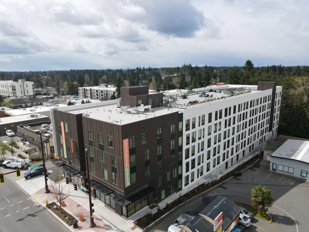 Aerial view of a modern multi-story apartment building updated by a professional Commercial Exterior Contractor Shoreline.