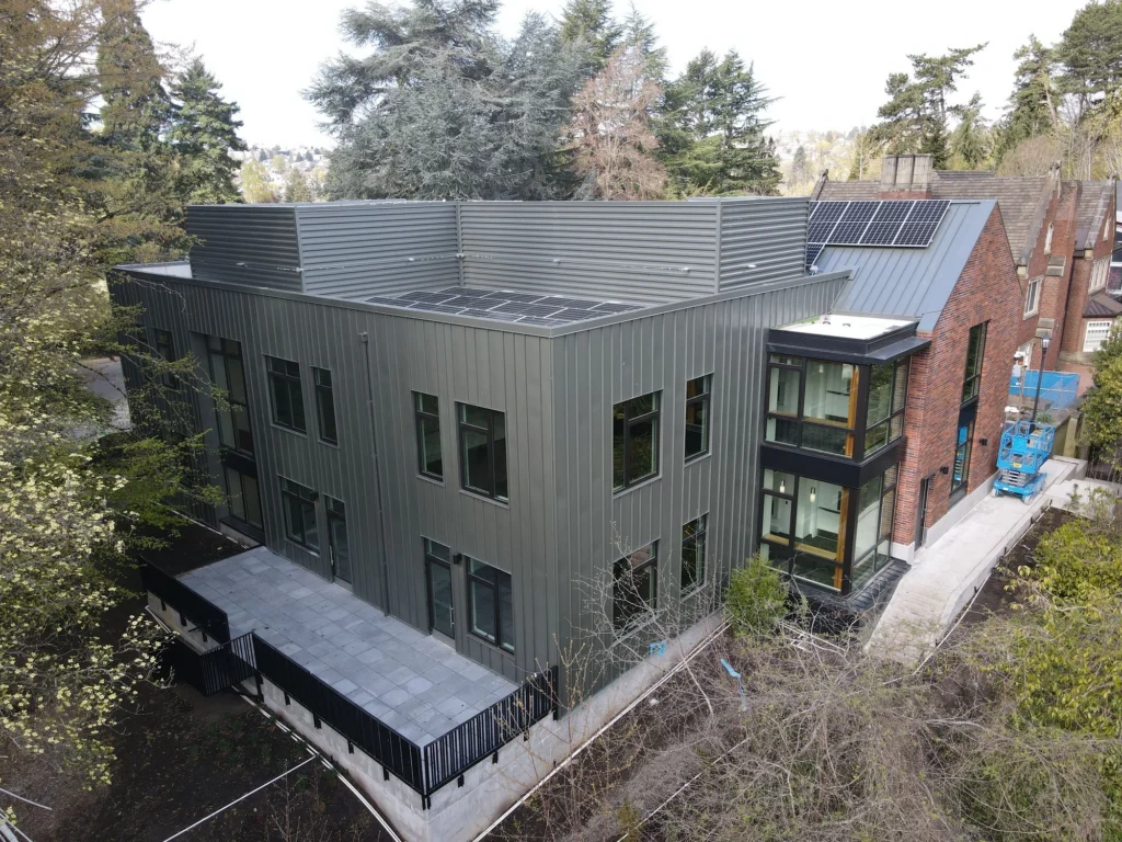 a large, modern grey commercial metal cladding Seattle building with large windows.